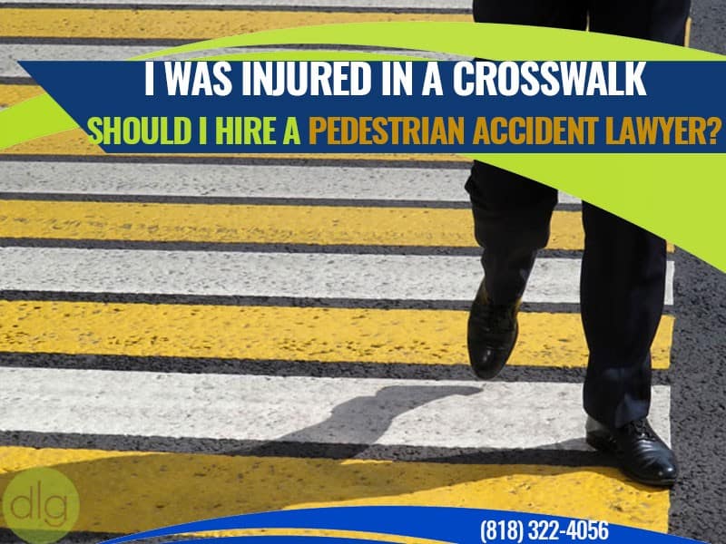 A person crosses a street at a crosswalk with text asking if one should hire a pedestrian accident lawyer after being injured.