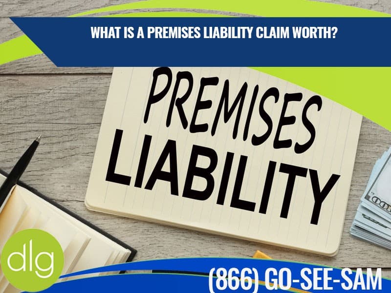 A notepad with "PREMISES LIABILITY" written on it, surrounded by office supplies, cash, and a banner asking about claim worth with a phone number displayed.