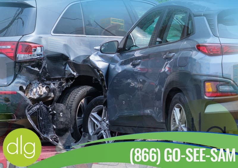 Two vehicles with significant damage after a collision; a phone number and "dlg" logo are visible in the foreground.